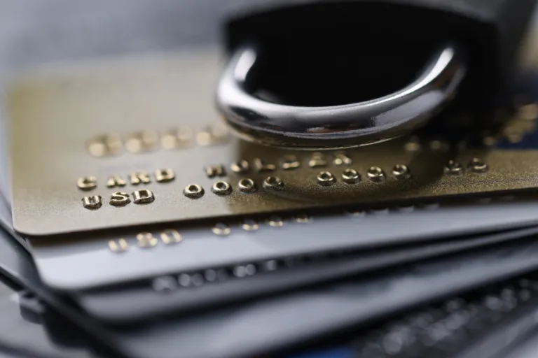 Plastic bank cards with a lock. Freeze cash and deposits concept
