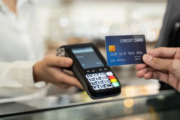 close-up-shot-of-customer-hand-using-dummy-credit-card-for-payment-to-waitress-at-cashier-in-cafe-restaurant-money-cashless-and-credit-card-payment-technology-concept-stockpack-istock Close up shot of customer hand using dummy credit card for payment to waitress at cashier in cafe restaurant, money cashless and credit card payment technology concept.