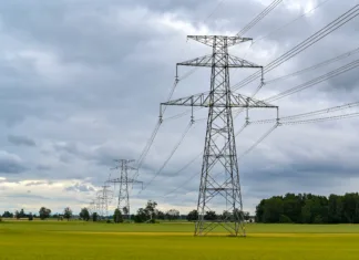 V Sloveniji elektrika med najcenejšimi v EU, sploh za gospodinjske odjemalce! Power lines over fields a cloudy summers day Narke Sweden july 24 2023