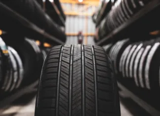 Pozor vozniki, bliža se 15. november A new tire is placed on the tire storage rack in the car workshop. Be prepared for vehicles that need to change tires.