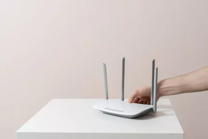hand-push-the-power-on-button-of-the-wifi-router-internet-connection-equipment-stockpack-istock hand push the power on button of the wifi router, internet connection equipment