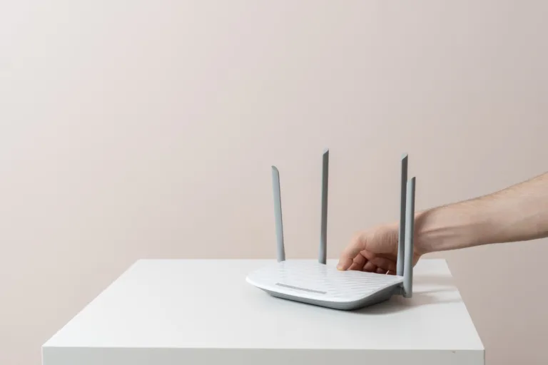hand push the power on button of the wifi router, internet connection equipment