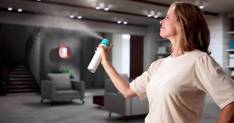 Woman Using Air Spray In Living Room