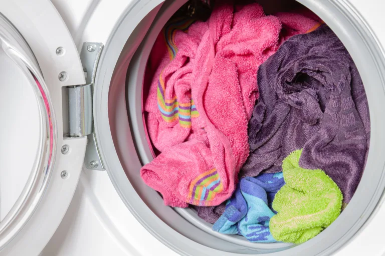 Colored towels in washing machine after washing.