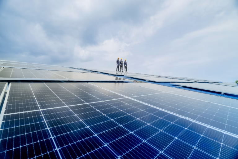 engineer man inspects construction of solar cell panel or photovoltaic cell by electronic device. Industrial Renewable energy of green power. factory worker working on tower roof.