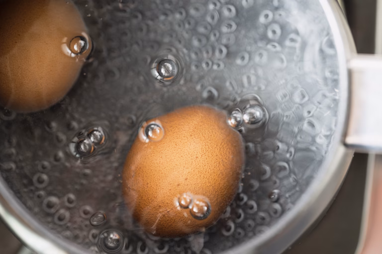 Boiling eggs in water. Food photo.