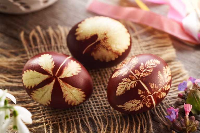Brown Easter eggs dyed with onion peels with spring flowers