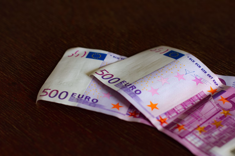 Two 500 euro bills on a dark background