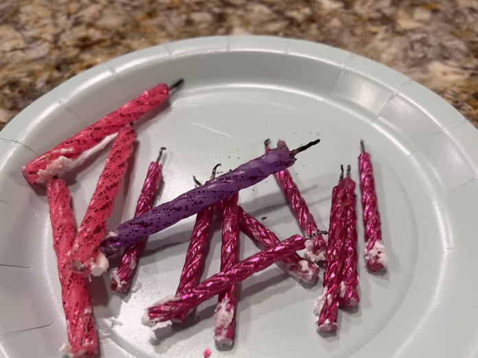 A plate full of used birthday candles.