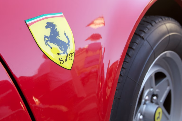 Faenza, Italy - August 21, 2011: Close up to the famous Ferrari logo on flaming red Ferrari 360 Modena parked in a Faenza square in Italy. The year production for this car is from 1999 to 2004. Ferrari is an italian luxury sports car manufacturer based in Maranello, Modena.