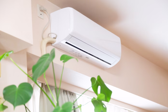 home-appliance-air-conditioner-and-green-plant-leaves-at-home-use-of-air-conditioner-has-been-encouraged-by-the-government-and-medical-doctors-to-cool-the-room-temperature-down-in-order-to-avoid-heat--stockpack-istock Home appliance air conditioner and green plant leaves at home. Use of air conditioner has been encouraged by the government and medical doctors to cool the room temperature down in order to avoid heat stroke risk due to the effect of global warming and climate change.