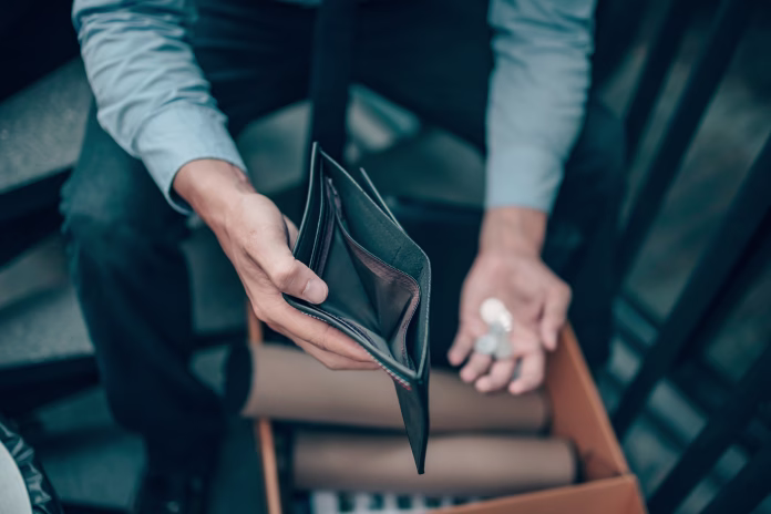 Office worker lost his job and open a wallet without money. Man empty wallet, man broke concept.