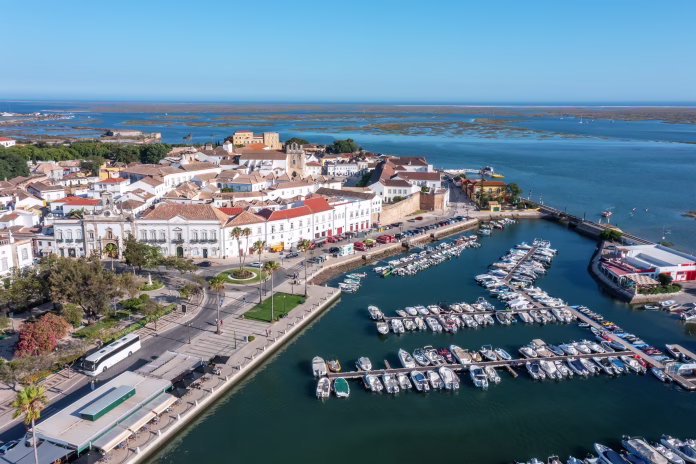 Aerial view of the city of Faro in Portugal with a view of the seaside tourist port and the old town in the background.