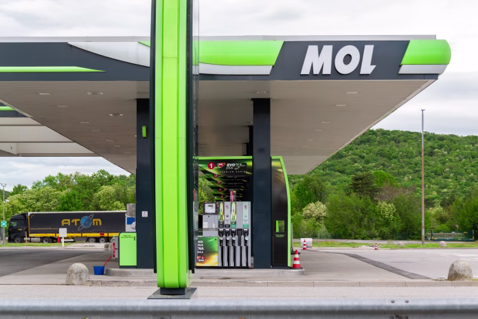Kozina, Slovenia- 25.04.2025- Modern MOL gas station with fuel pumps on highway and forest background