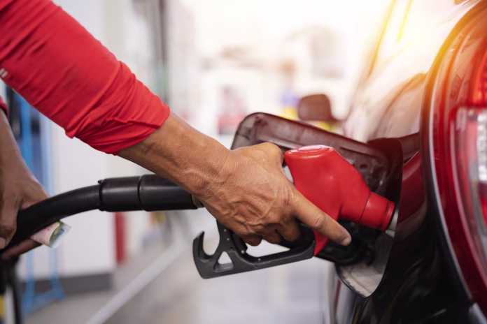 refueling-the-car-at-a-gas-station-fuel-pump-man-driver-hand-refilling-and-pumping-gasoline-oil-the-car-with-fuel-at-he-refuel-station-car-refueling-on-petrol-station-fuel-pump-at-station-stockpack-istock Refueling the car at a gas station fuel pump. Man driver hand refilling and pumping gasoline oil the car with fuel at he refuel station. Car refueling on petrol station. Fuel pump at station