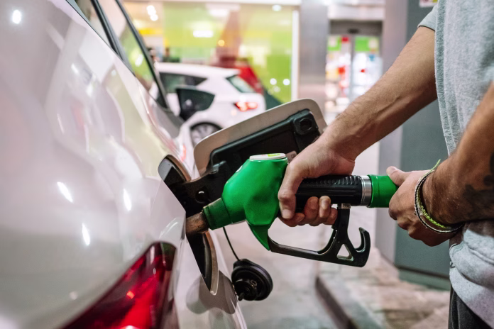 unrecognizable-male-putting-fuel-dispenser-in-tank-while-refueling-vehicle-on-self-service-gas-station-high-quality-photo-stockpack-istock Unrecognizable male putting fuel dispenser in tank while refueling vehicle on self service gas station. High quality photo
