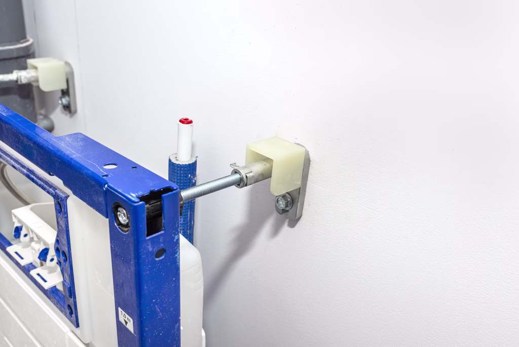 Newly installed WC concealed frame for wall-mounted toilet, screwed to the wall and floor.
