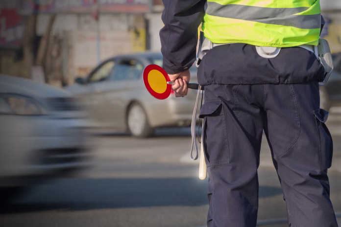 Traffic cop waiting to write a ticket.