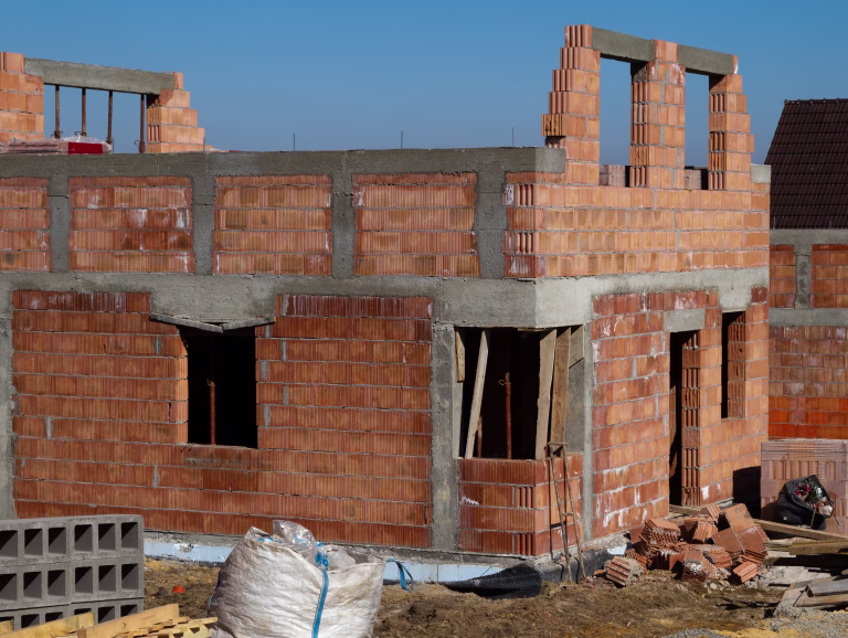Single-family home made of hollow blocks or bricks. New unfinished stand-alone house building under construction.