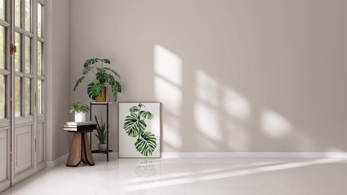 Empty room with light beige wall, monstera plant, poster frame and green tropical plant in sunlight from glass door on white floor for interior design decoration, lifestyle product background 3D