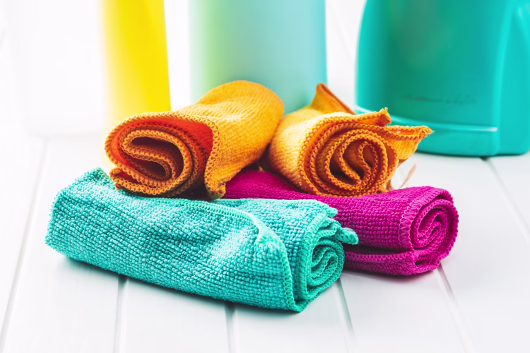 Microfiber cleaning towels on white table.