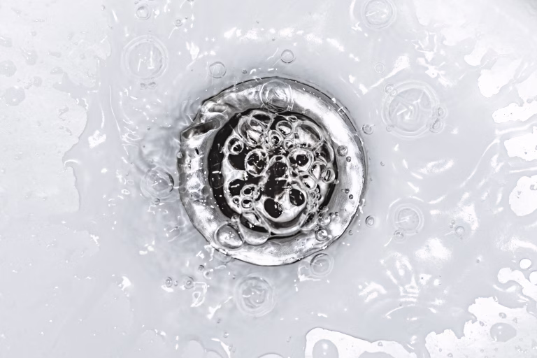 Slow bathroom sink drain. Household plumbing problem. Water draining down slowly in wash basin. Drain cleaning and unclog