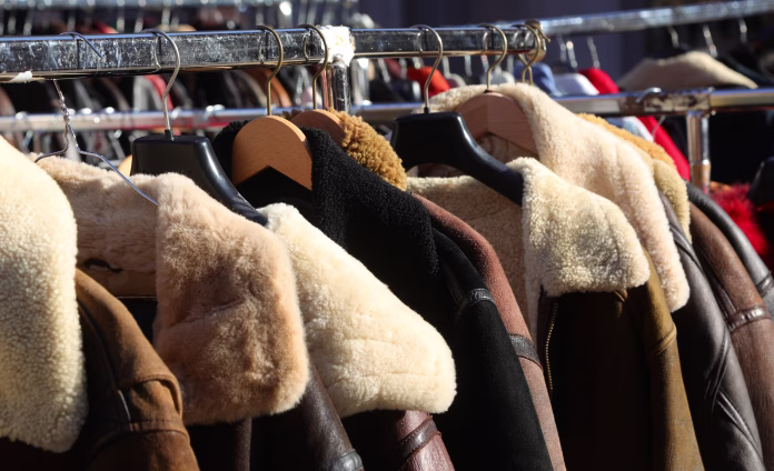 many used clothes for sale at the vintage clothing stall in the flea market