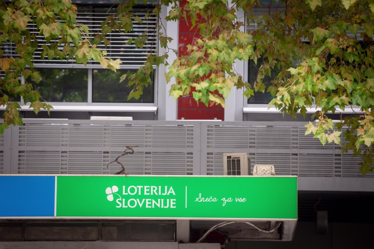 Picture of a sign with the logo of Loterija Slovenije on their local office for Maribor, Slovenia. Loterija Slovenije is the of the state owned national lottery of Slovenia.