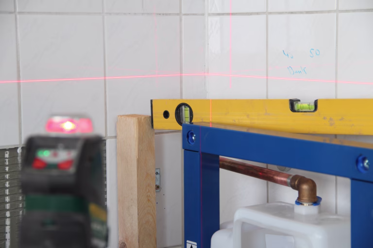 Plumber at work with a laser beam