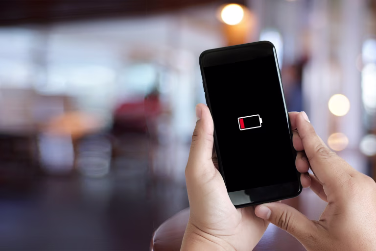 Close up man hands using smart phone battery low charged battery screen