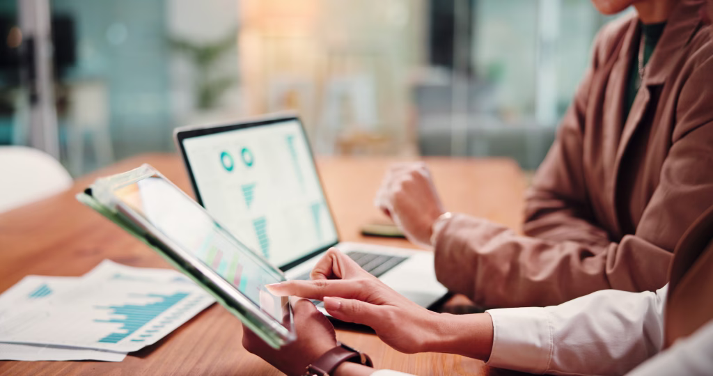 Hands, people and graphs on tablet in office for finance results, profit growth and budget review. Employees, team and digital with financial report, revenue stats and comparison for risk assessment