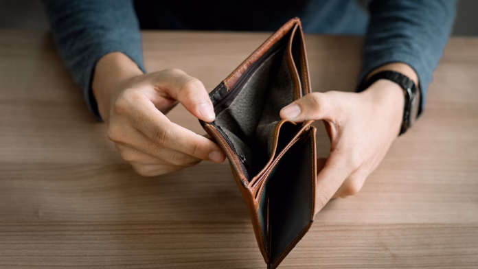 Poor people go bankrupt, empty wallet (no money) in the hands of a man Bankruptcy due to economic downturn, no credit, no emergency savings, crisis, High cost of living in city concept.