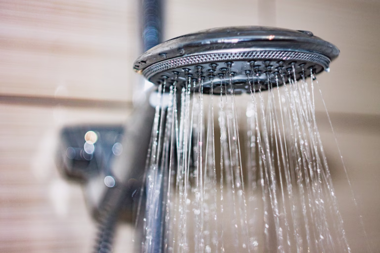 shower head with drops of water falling down PIPE WATER