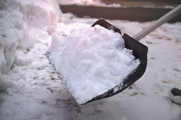 snow shovel man doing winter service plow