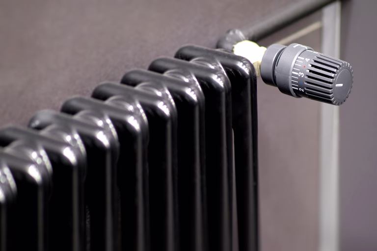 A sleek black radiator with an adjustable thermostat for optimal heating comfort and efficiency in your space