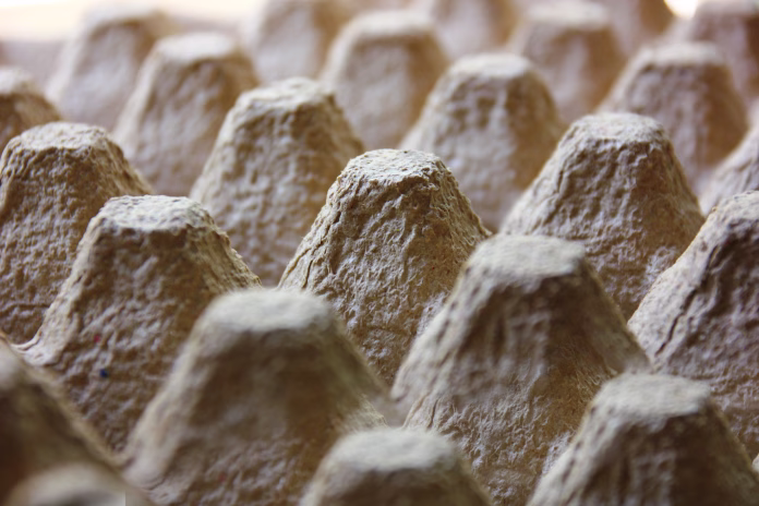 close up old brown paper recycled into egg trays triangle shape abstract background