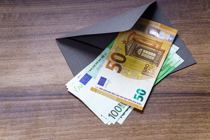 European euro banknotes and envelope on table closeup