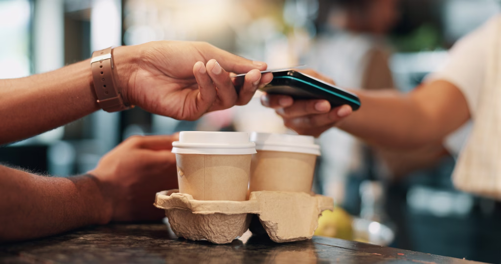 Hands, credit card and payment in coffee shop, people and transactions with hospitality. Closeup, barista and client in cafe, ecommerce or customer service at POS, spending or support for local store