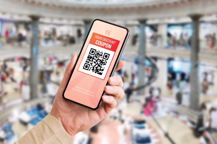 Person using discount coupon on mobile phone at store