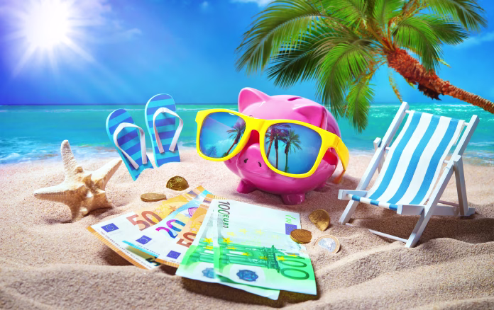 piggy-bank-with-sunglasses-relax-on-the-beach-holiday-travel-money-savings-concept-summer-vacation-stockpack-istock Piggy bank with sunglasses relax on the beach holiday. Travel money savings concept, summer vacation