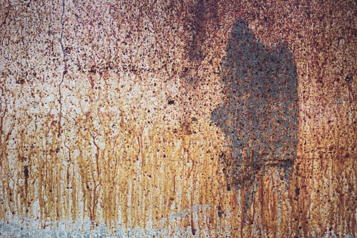 the texture of grease and dirt on a long-unwashed stove and oven