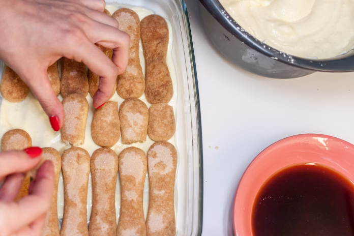 tiramisu preparation at home wooman hands cooking
