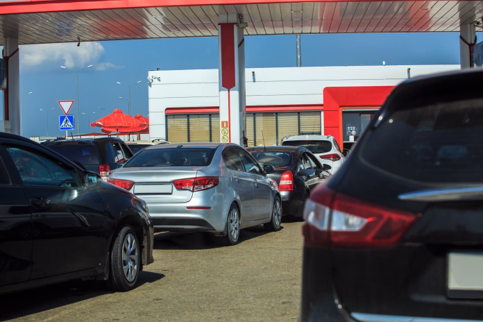 Cars at a petrol station in a queue on a sunny summer day
