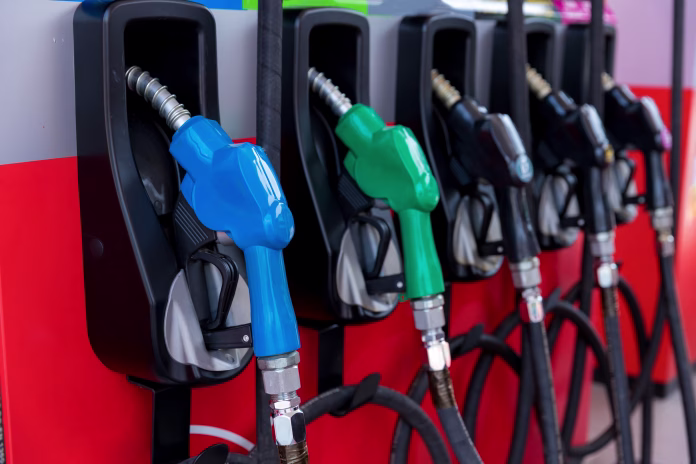 Fuel Pump, Gas Station, Gasoline. Colorful Petrol pump filling nozzles isolated on white background , Gas station in a service in warm sunset. Head fuel vehicle refueling facility in Asia