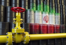 Bo konflikt na Bližnjem vzhodu udaril po žepih Slovencev? Minister Han: Razlogov za paniko ni Oil pipe line valve in front of the Iranian flag on the oil barrels. Iranian gas and oil fuel energy concept. 3d illustration