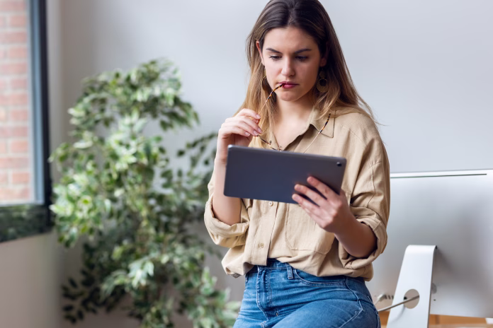 Shot of smart freelance business woman working with digital tablet in her startup.