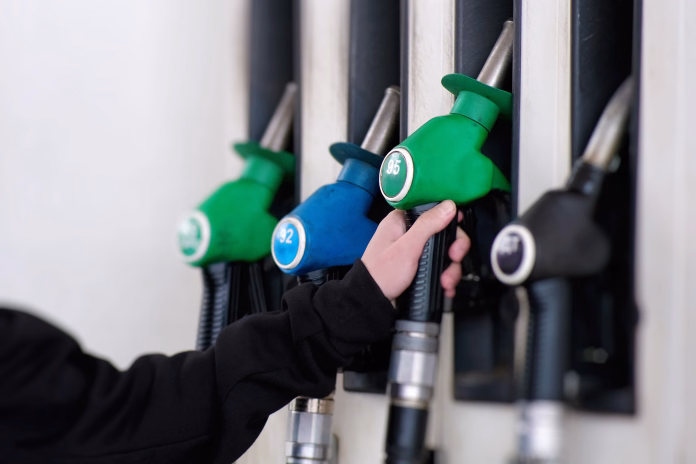 A closeup view of vibrant fuel pumps at a bustling service station, fully prepared for vehicle refueling at any moment