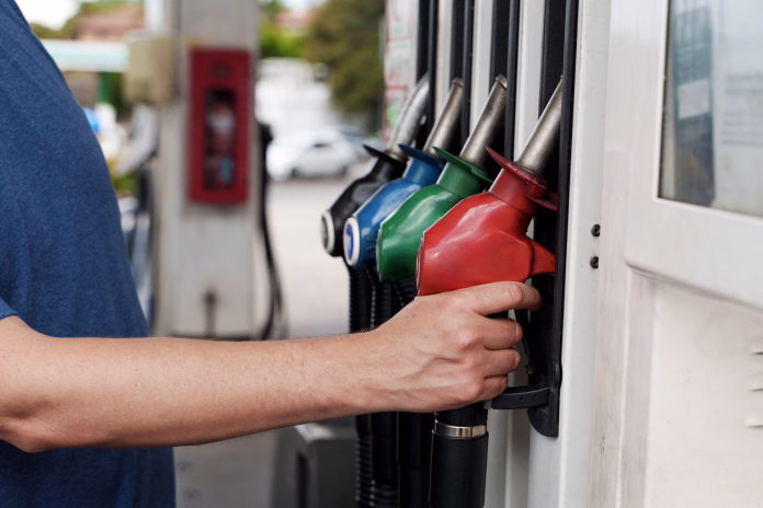 A man is filling ap car at a petrol station