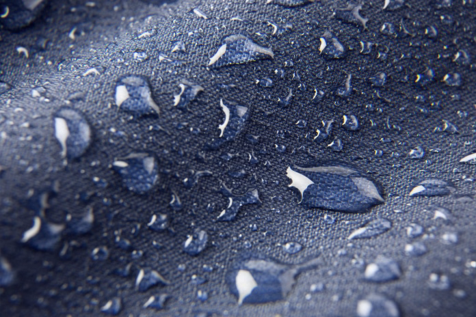 blue-waterproof-membrane-textile-background-with-drops-stockpack-istock Blue waterproof membrane textile background with drops