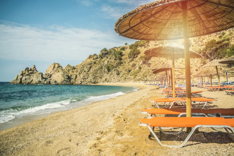 Straw beach umbrella with sea ocean beach background travel concept tourism concept exotic beach